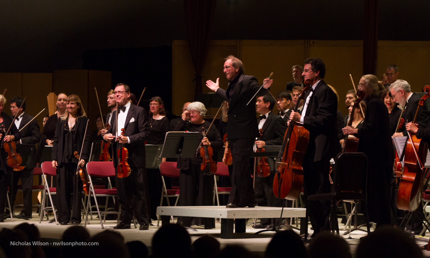 Maestro Allan Pollack and the Festival Orchestra stand to acknowledge applause during the opening concert.