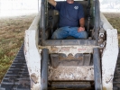 David Lindstrom in the cab of his Bobcat dozer during the tent raising.