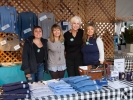 Leona Walden and Sally Stewart with two other volunteers in the festival merchandise booth.