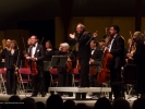 Maestro Allan Pollack and the Festival Orchestra stand to acknowledge applause during the opening concert.