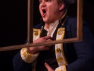 The Officer (James Russell) remains frozen in shock for several minutes as the opera continues around him